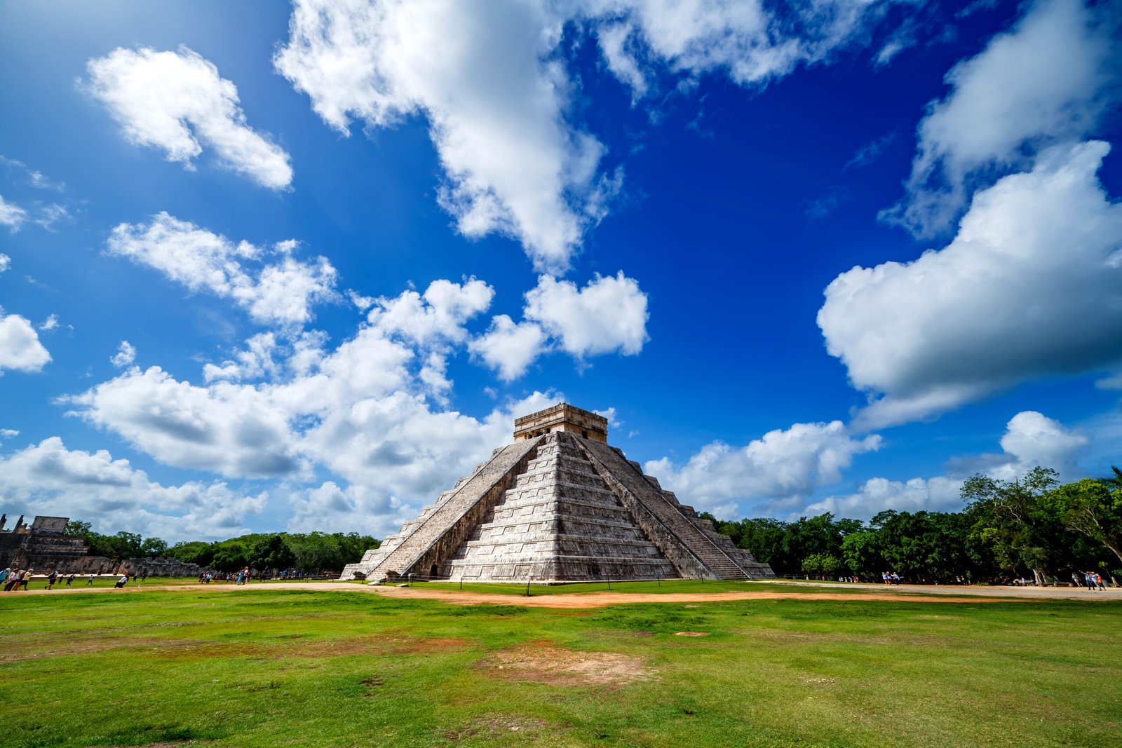 amazing view of the Pyramid of Chichen Itza, in the mayan riviera, with blue sky and green grass